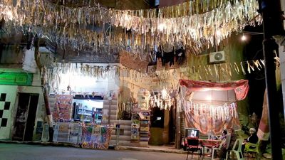 Women sitting in the street watching the television, street, ramadan decorations