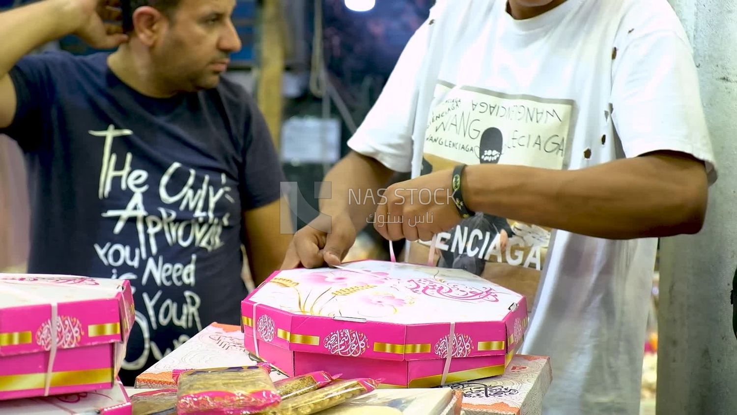 Man ties the box of the candies of Prophet Muhammad&#39;s Birth to sell it