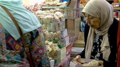 Woman puts the candies of the prophet Muhammad&#39;s birth on the box