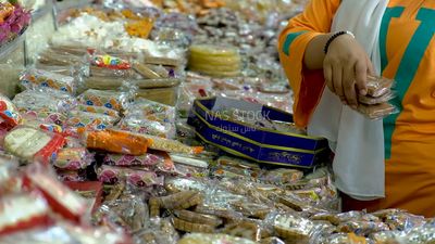 Girl chooses the candies of the prophet Muhammad&#39;s birth to buy it