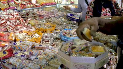 Man puts the candies of the prophet Muhammad&#39;s birth on the box