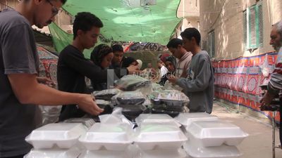View of people in Matareya sharing their iftar together in the street, Ramadan Kareem, preparing their iftar