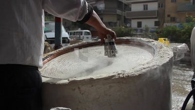 Man making handmade Kunafa in store, Ramadan sweets, Ramadan Kareem