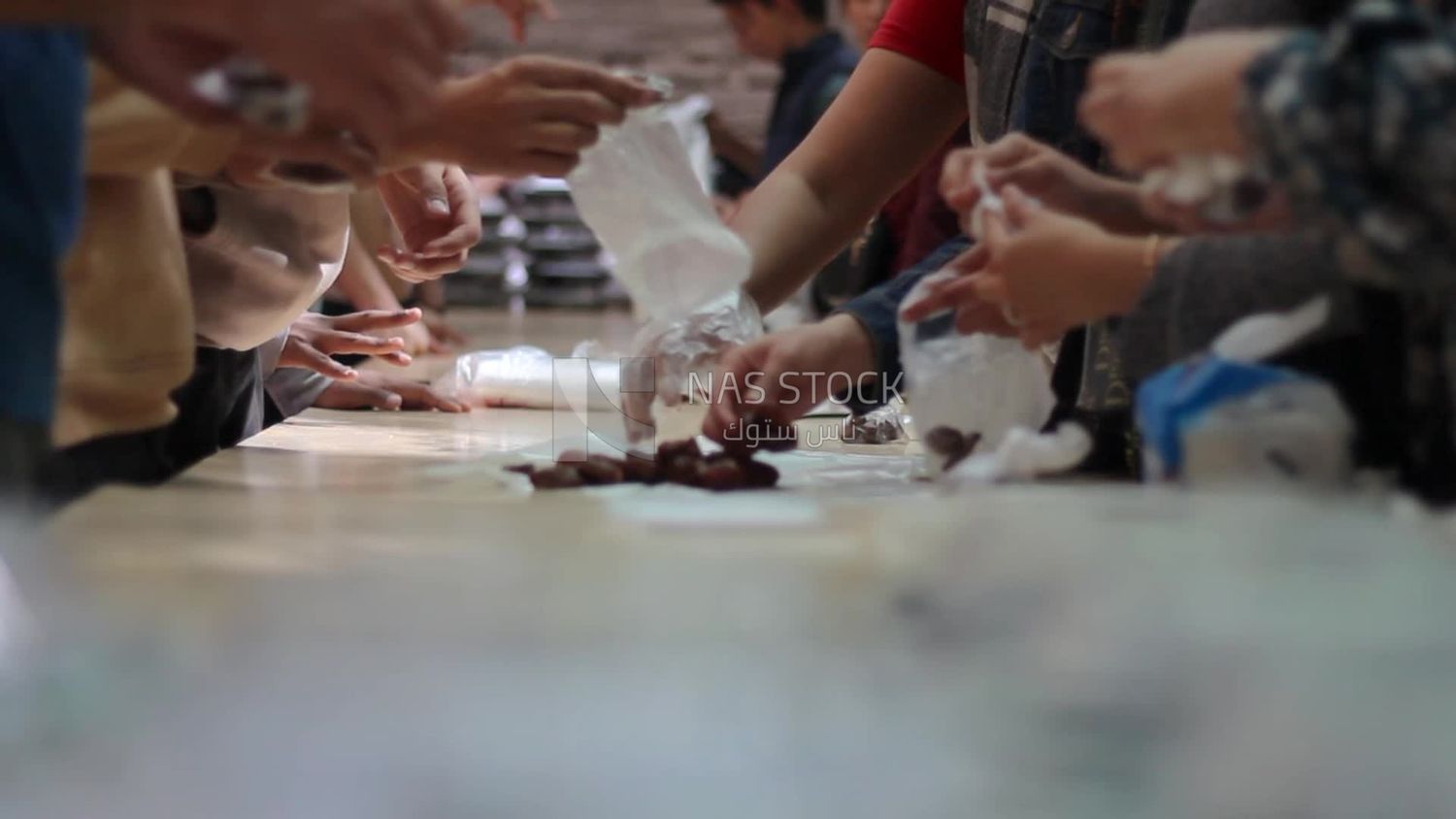 People put dates in bags to distribute for iftar,  Ramadan Kareem, preparing their iftar