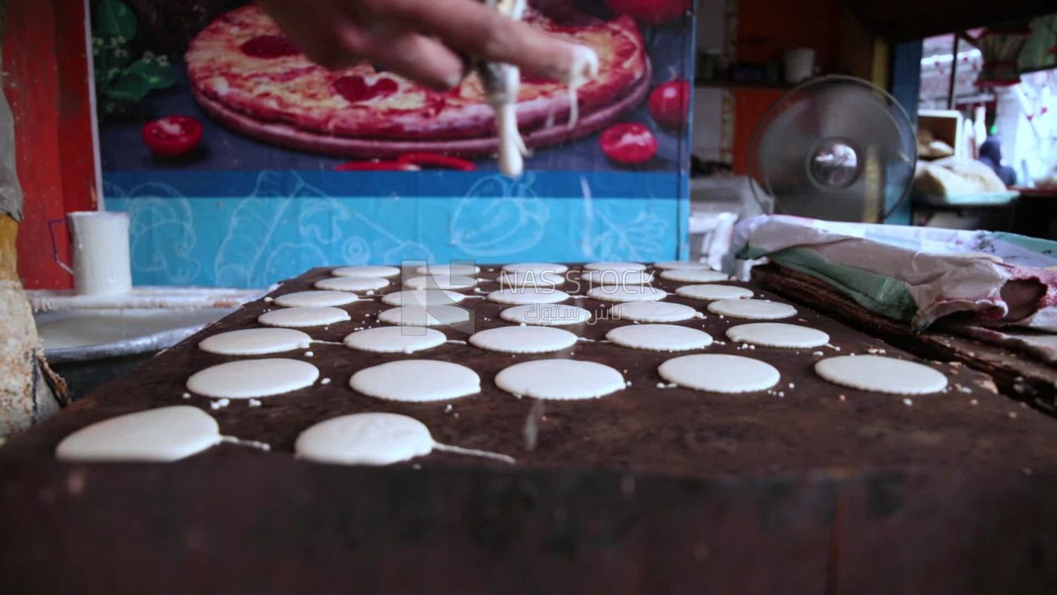 Man standing in qatayef store, Ramadan sweets, Ramadan kareem