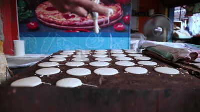 Man standing in qatayef store, Ramadan sweets, Ramadan kareem