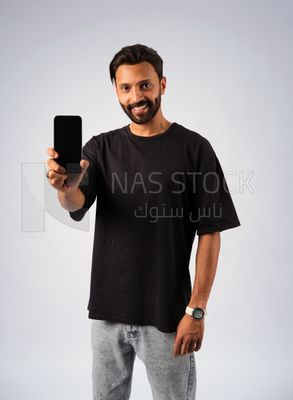 Guy in youth clothes and holding a mobile