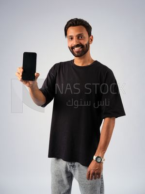 Guy in youth clothes and holding a mobile