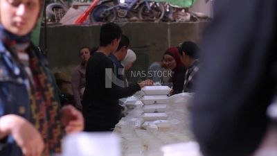 View of people in Matareya sharing their iftar together in the street, Ramadan Kareem, preparing their iftar