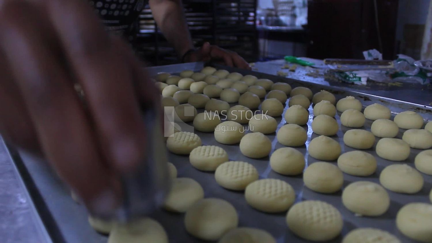 Man making Kahk in bakery shop, bakery store, Eid