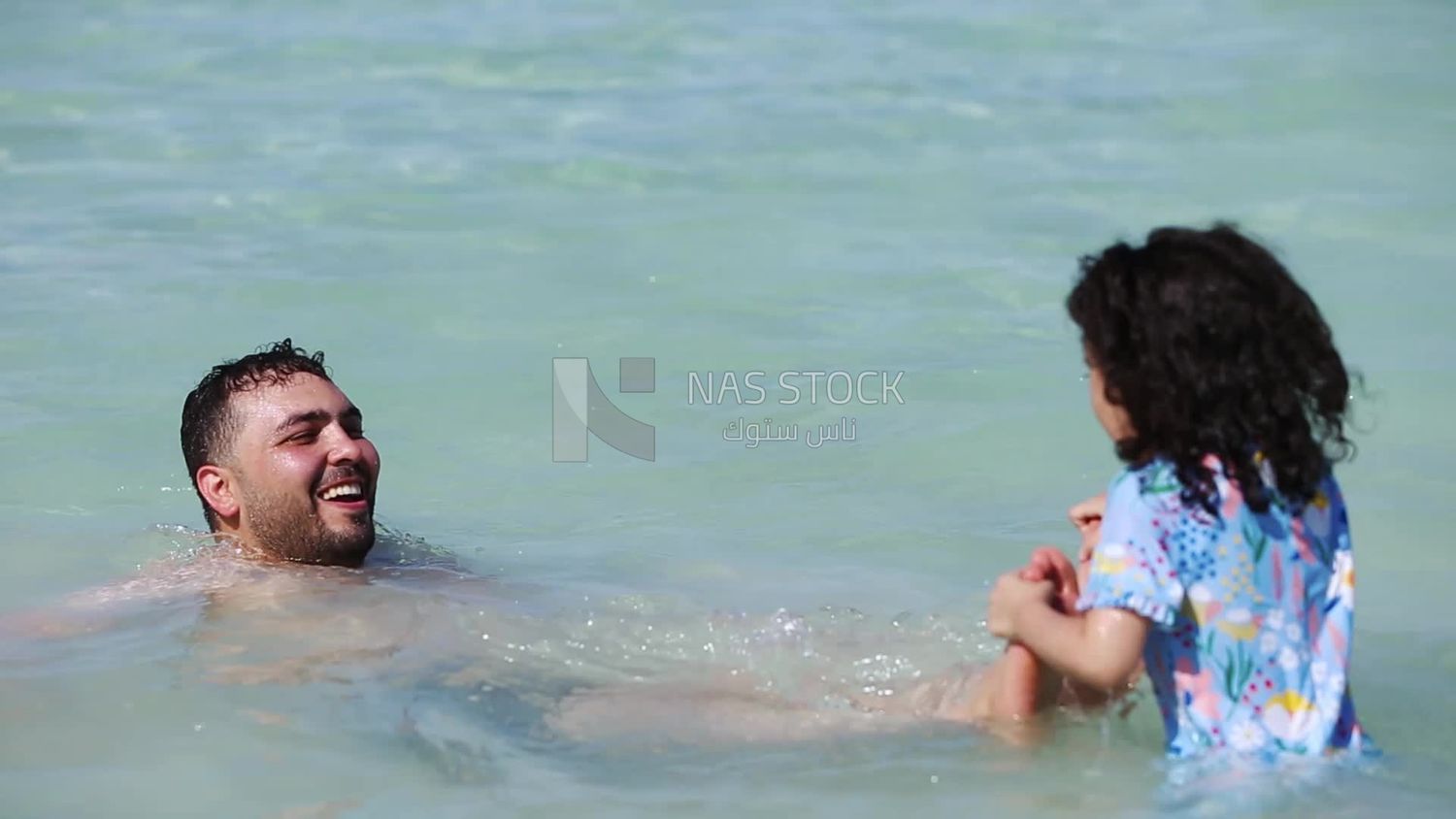 Father enjoying swimming with his daughter