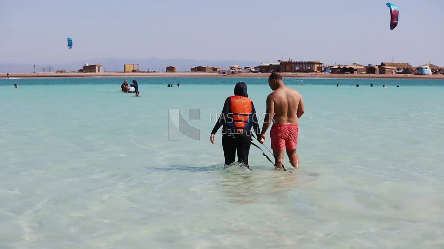 Couple walking in the water enjoying a swim and the refreshing summer weather
