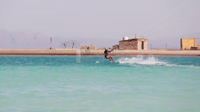 Young man wearing a swimsuit and doing water skiing