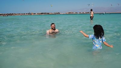 Father enjoying swimming with his daughter
