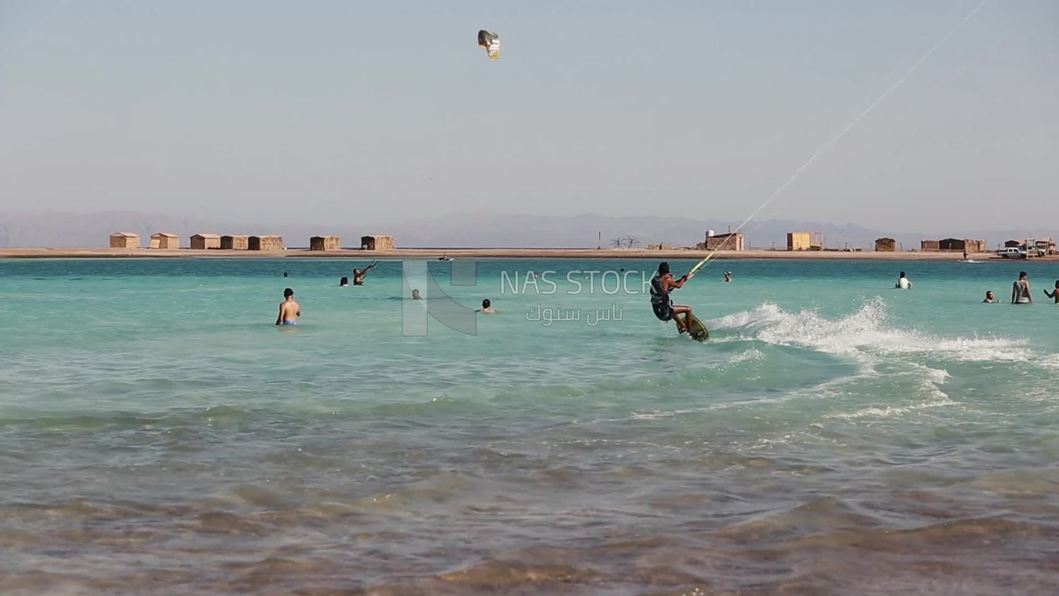 Young man wearing a swimsuit and doing water skiing