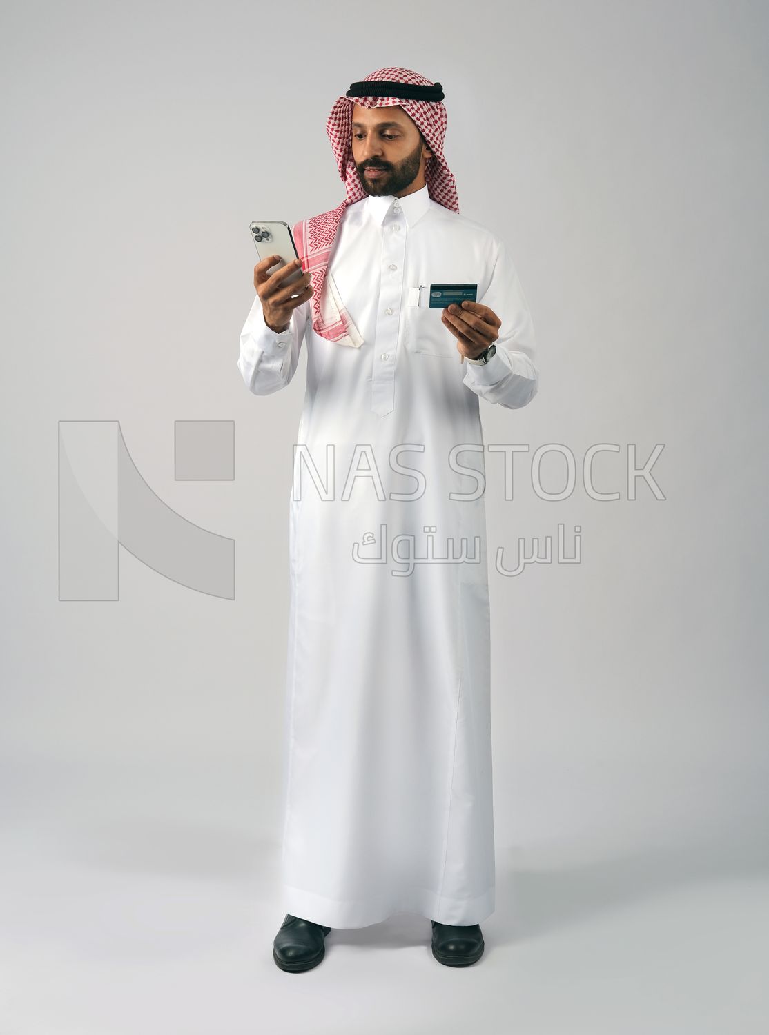 Gulf man holding phone and bank card