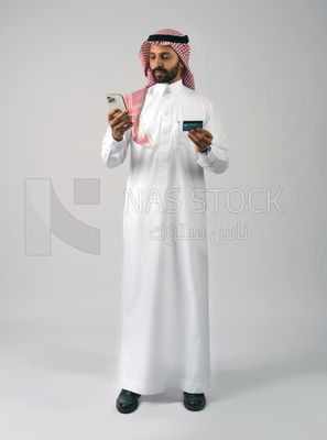 Gulf man holding phone and bank card