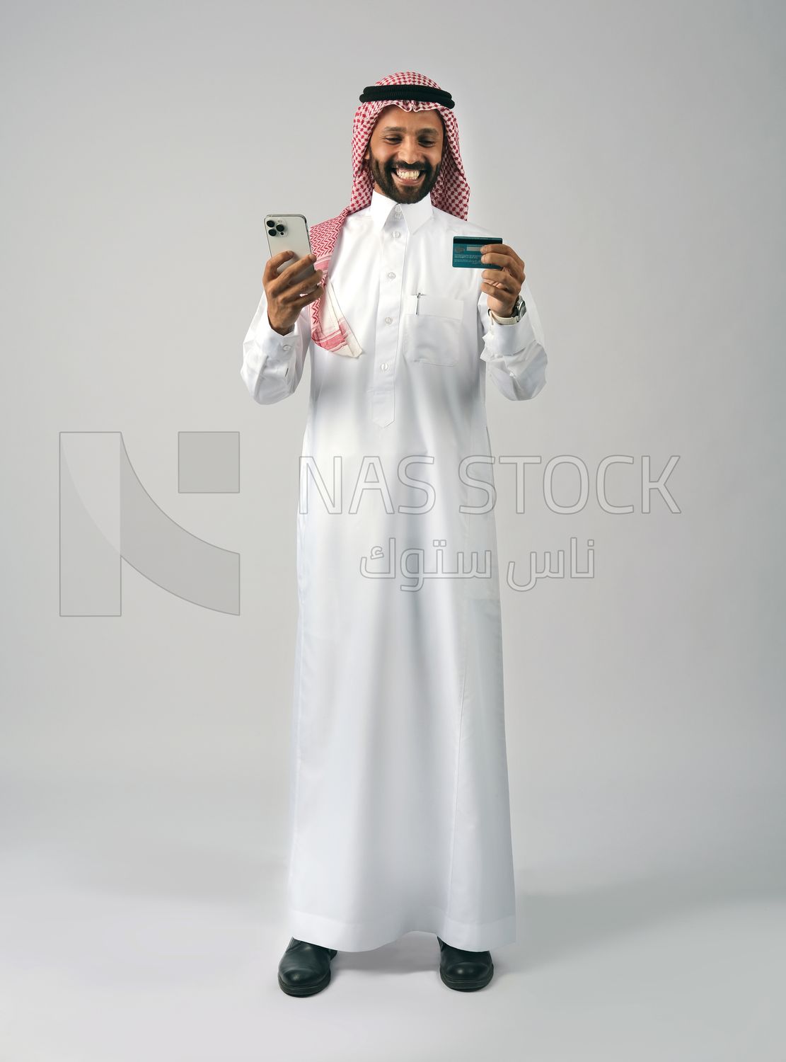 Gulf man holding phone and bank card