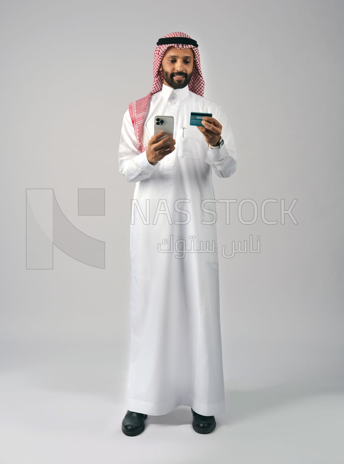 Gulf man holding phone and bank card