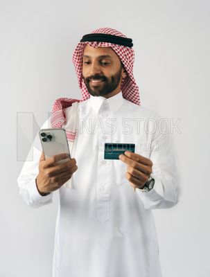Gulf man holding phone and bank card