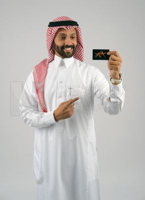 رجل خليجي يمسك بطاقة