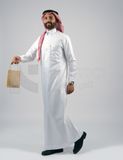 Gulf man holding a shopping bag