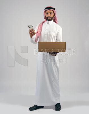 رجل خليجي يحمل بيده صندوق كرتوني