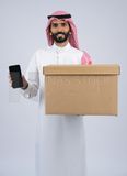 Gulf man holding a Cardboard box and Mobile phone