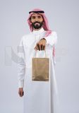 Gulf man holding a Paper bag