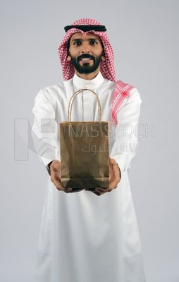 Gulf man holding a Paper bag