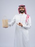 Gulf man holding a Paper bag