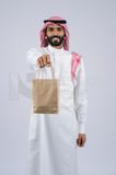 Gulf man holding a Paper bag