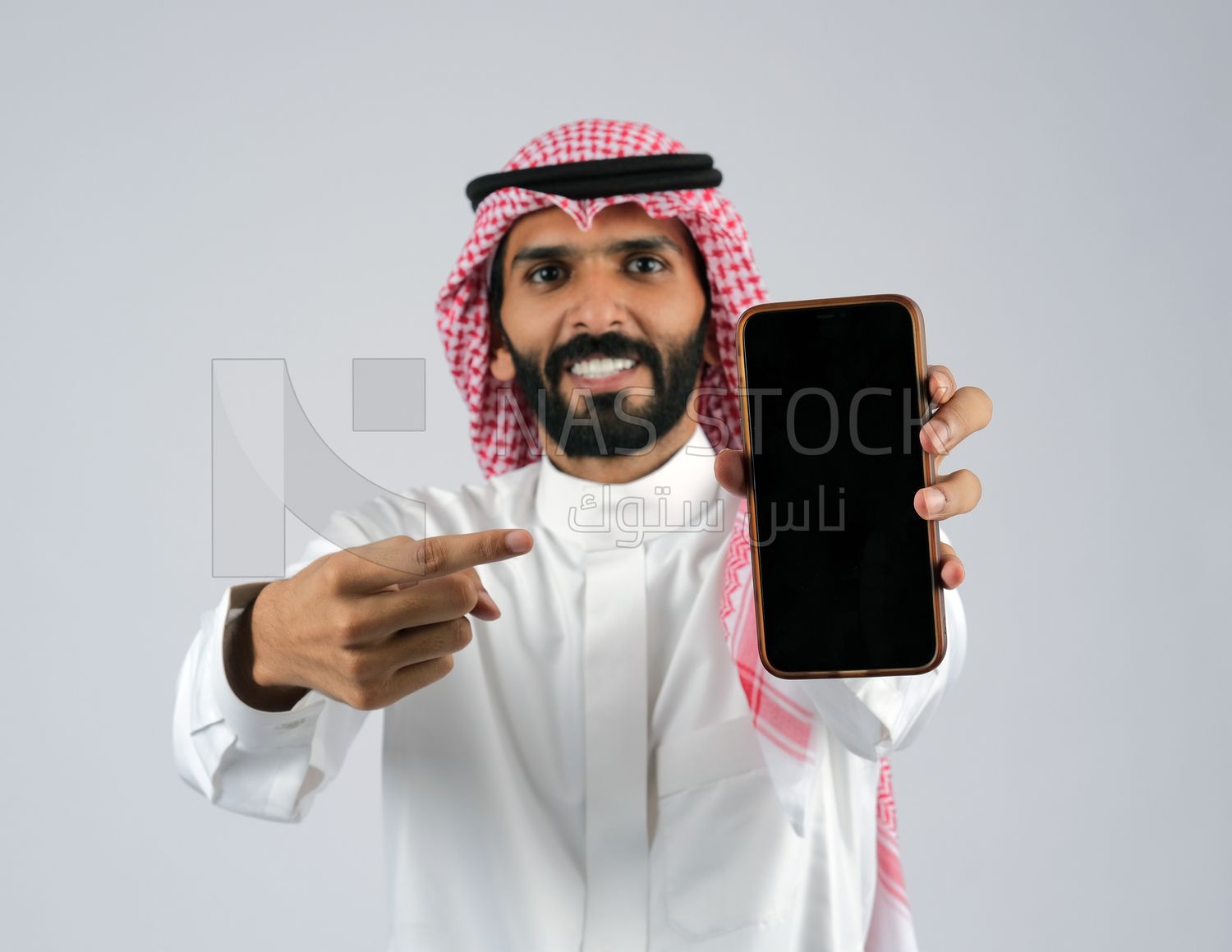 Gulf man holding a mobile phone