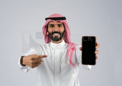 Gulf man holding a Mobile phone