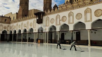 Cleaners clean the courtyard of Al-Azhar Al-Sharif Mosque in Cairo, Egypt