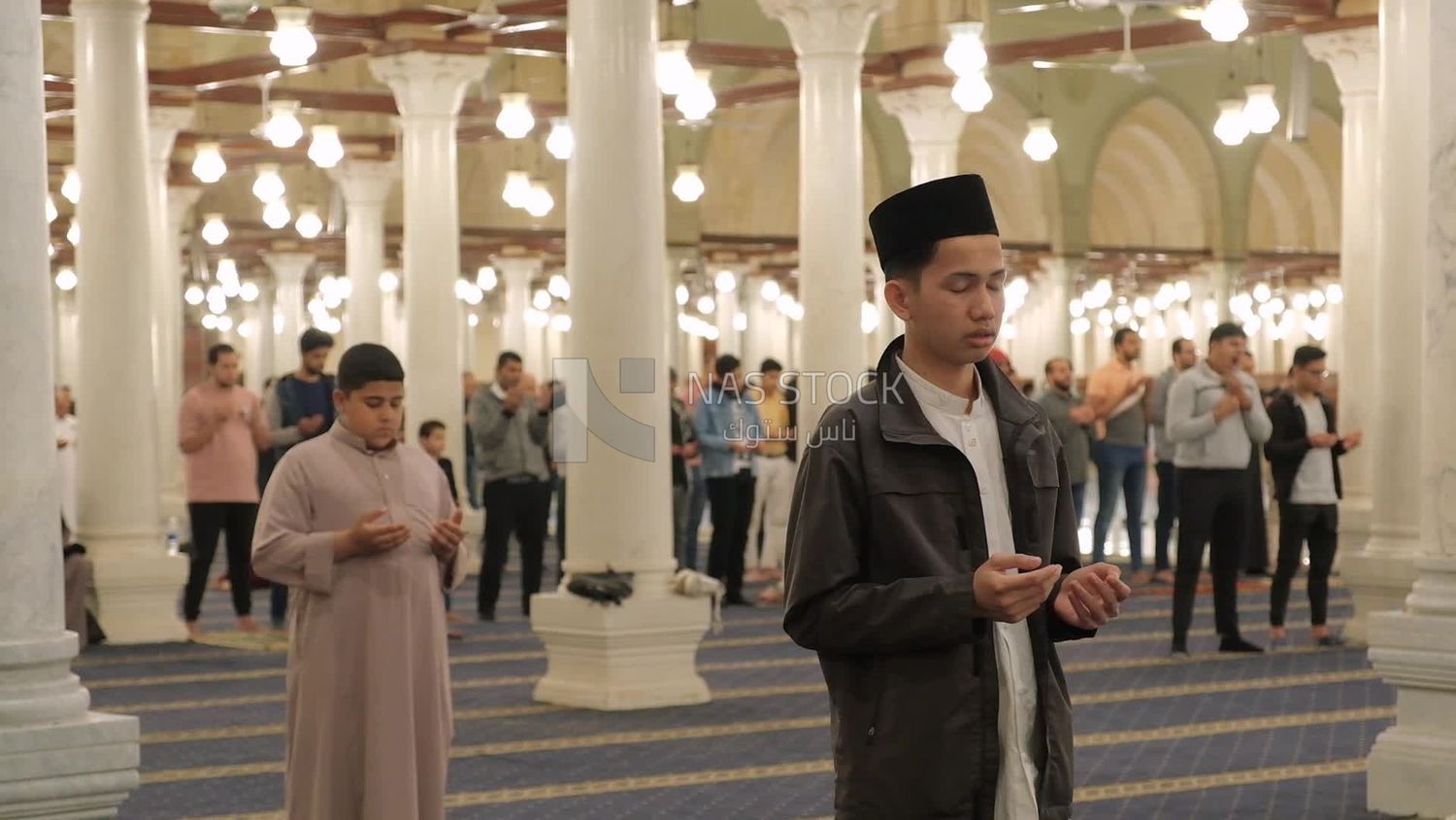 Man in the mosque, praying to God, praying on the prayer rug, performing the obligatory prayer in the mosque, worship and draw close to God