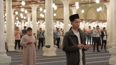 Man in the mosque, praying to God, praying on the prayer rug, performing the obligatory prayer in the mosque, worship and draw close to God