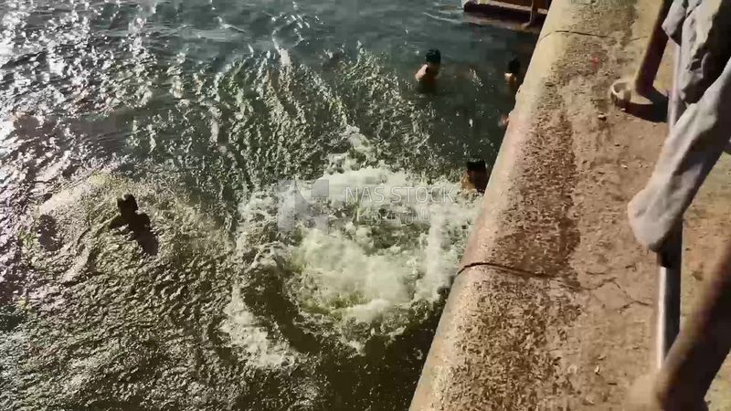 Man enjoys jumping and swimming in the Nile River