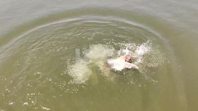 Man throwing and swimming in the Nile River, summer activities, swimming