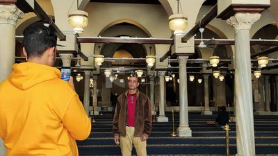 Man takes a picture inside Al-Azhar Mosque