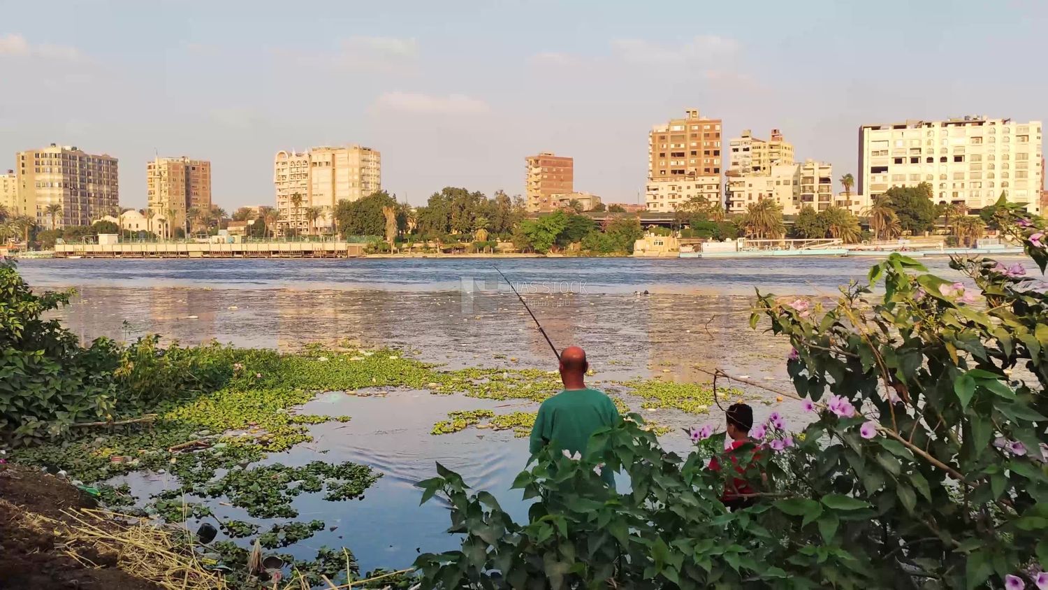 Egyptian man enjoys fishing with his son