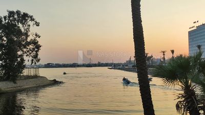 Small boats sailing in the Nile River at sunset