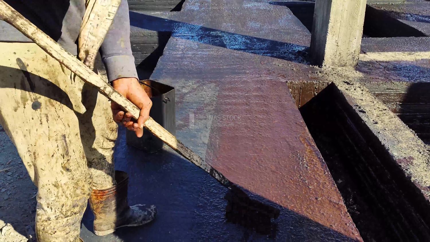 Worker paints the structure with an anti-rust material to protect the concrete from corrosion