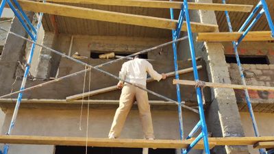 Worker who finishes the facade of the buildings