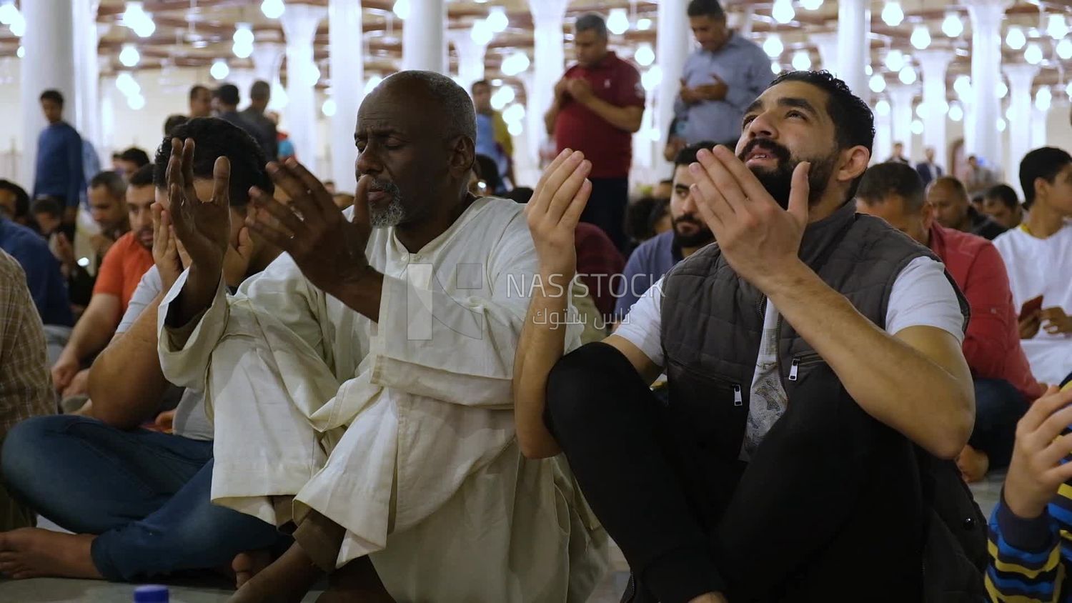 Worshipers praying in a mosque, performing the obligatory prayer in the mosque, worship and draw close to God