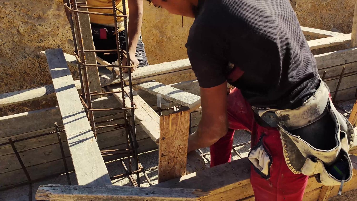 Carpenter working on a construction site who shapes and installs wooden pieces