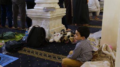 Boy in the mosque, praying on the prayer rug, performing the obligatory prayer in the mosque, worship and draw close to God