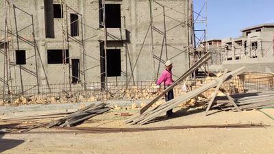 Construction worker stacking and sorting the wood used in construction
