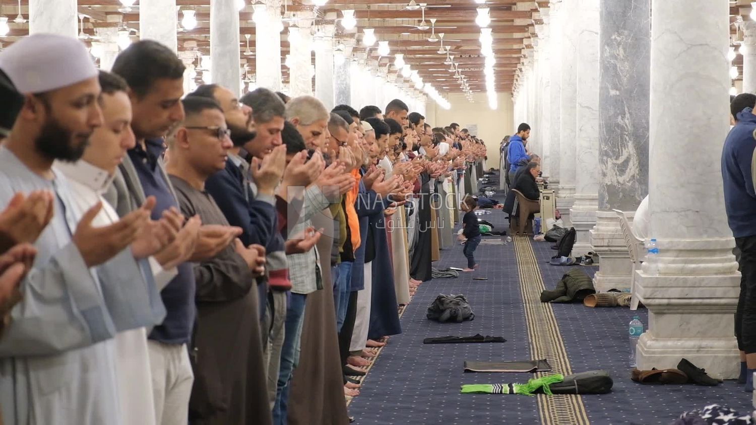 Worshipers praying in a mosque, performing the obligatory prayer in the mosque, worship and draw close to God
