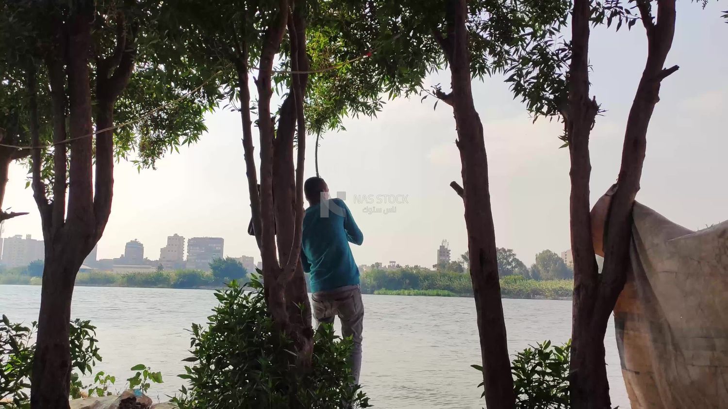 Egyptian young man fishing in the Nile River